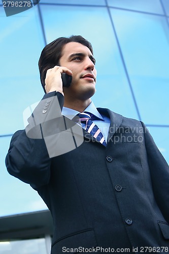 Image of a businessman using mobile phone b