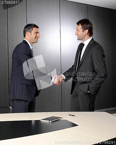 Image of Serious businessmen shaking hands