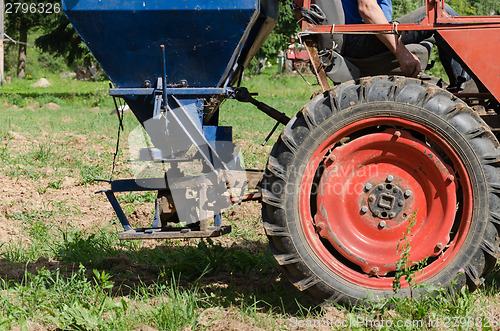 Image of tractor wheel seeder equipment sow buckwheat seeds 