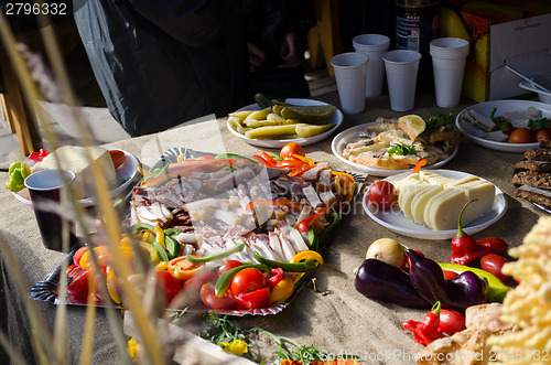 Image of tray with meat vegetable sausage slices on table 