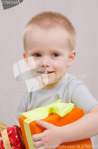 Image of Year-old boy with a gift looks right