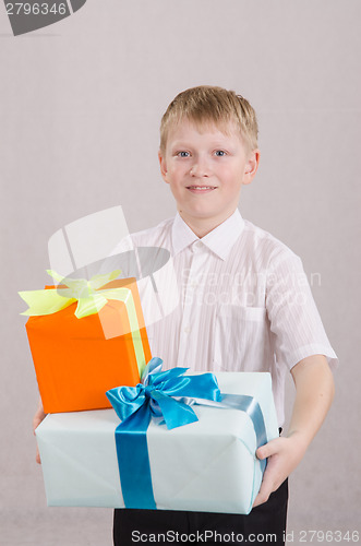 Image of Portrait of teenage boy with gifts in their hands