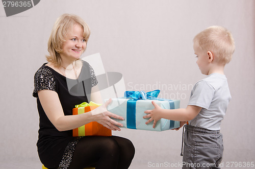 Image of Year-old boy presents a gift to mum