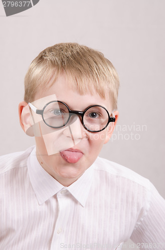 Image of Teenager in glasses showing tongue