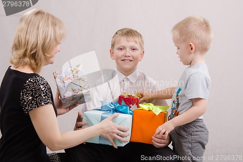 Image of Mother and brother give teen gifts
