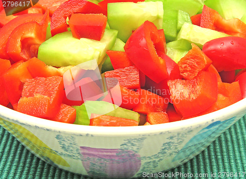 Image of Slices of cucumber and red pepper in a ceramics bowl