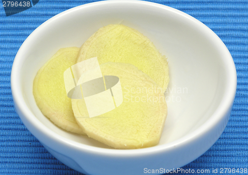 Image of Ginger in a bowl of chinaware on blue background