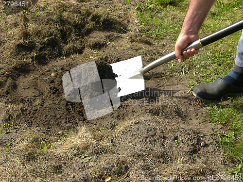 Image of Cutout man with spade doing work in the garden