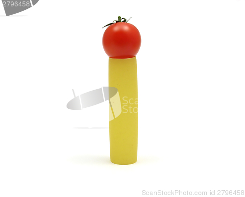 Image of One unboiled canneloni with one red tomato 