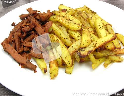 Image of Soy Geschnetzeltes and french fries on white plate