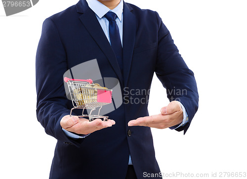 Image of Businessman putting coin into trolley 