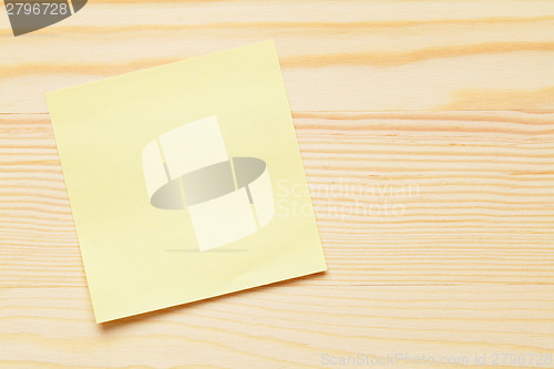 Image of Yellow notepad over wooden background