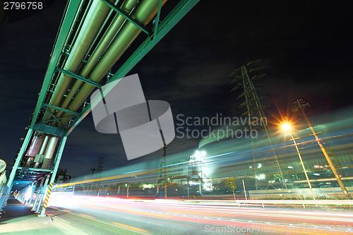 Image of Industrial factory with traffic trail at night