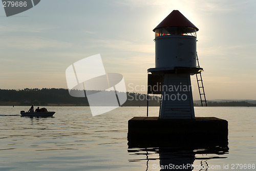 Image of A boat and a lighthouse.