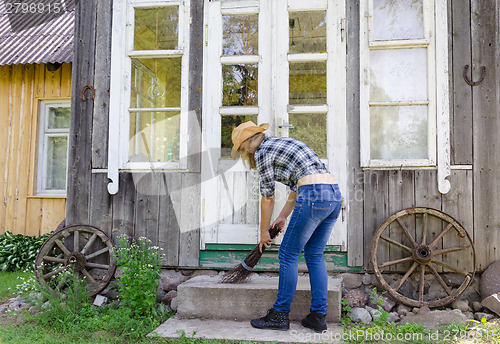 Image of Worker woman clean sweep stairs with wooden broom 