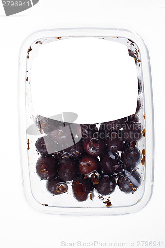 Image of olives in plastic box surface