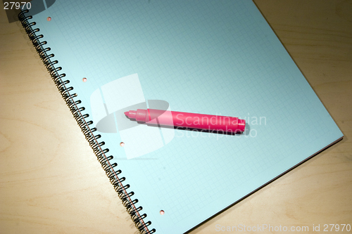 Image of red marker on blue notepad