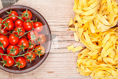 Image of uncooked pasta and fresh tomatoes