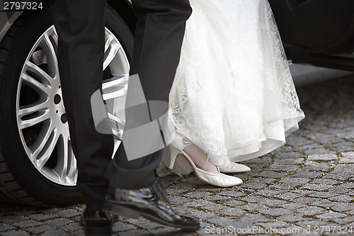 Image of Bride and groom getting out of the car