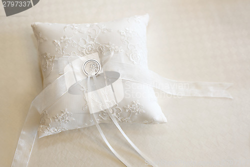 Image of Wedding rings on a white ring pillow