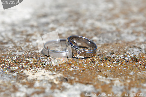 Image of Wedding rings on a stone wall