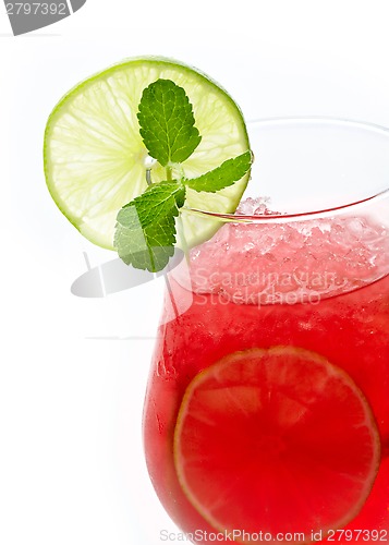 Image of Glass of red cocktail with lime slices