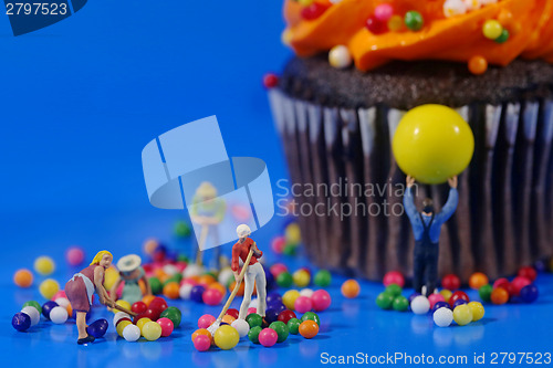 Image of Plastic People Cleaning Up a Messy Cupcake