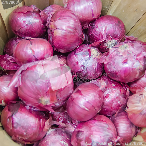 Image of red onions in basket on display on market farm