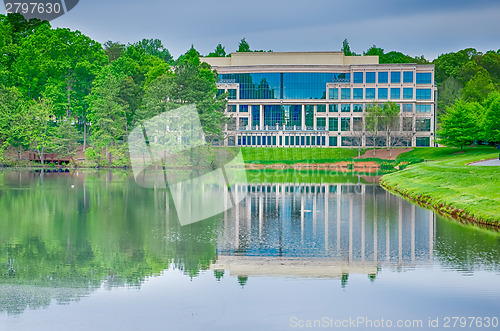 Image of office building reflecting in lake