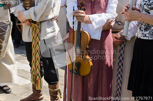 Image of female hand hold folk instrument violin  