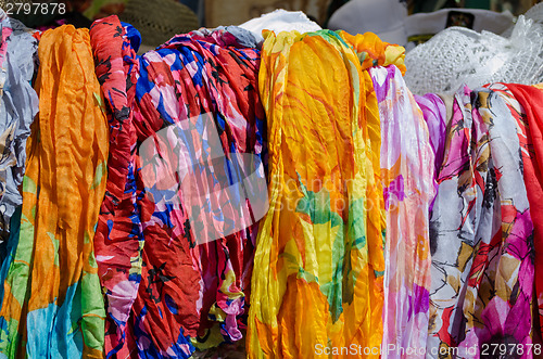 Image of multicolor cloaks shawls and scarves sold in fair 