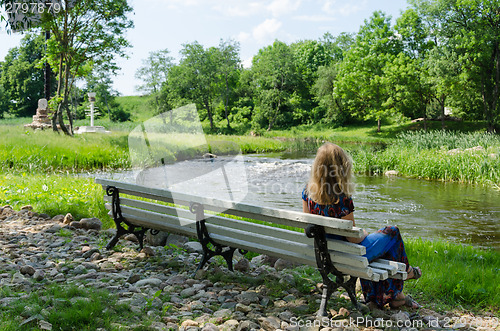 Image of woman on bench admire fast flow river water stream 