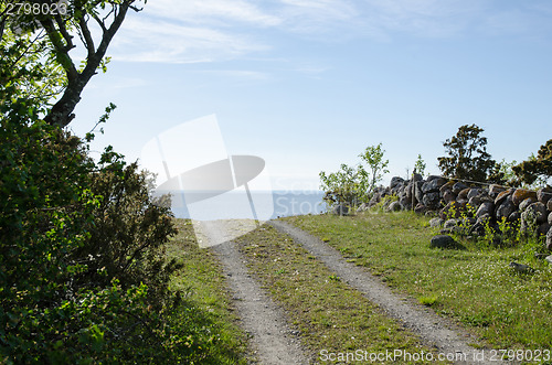 Image of Rural tracks with blue sky and blue water ahead