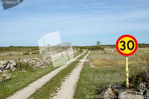 Image of Speed limit sign at rural tracks in a plain grassland