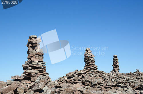 Image of Group of rock piles at a clear blue sky