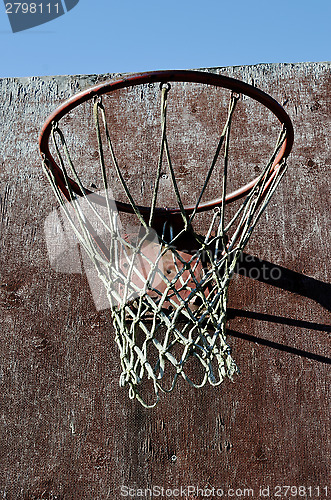 Image of closeup of old basketball backboard and hoop outdoor