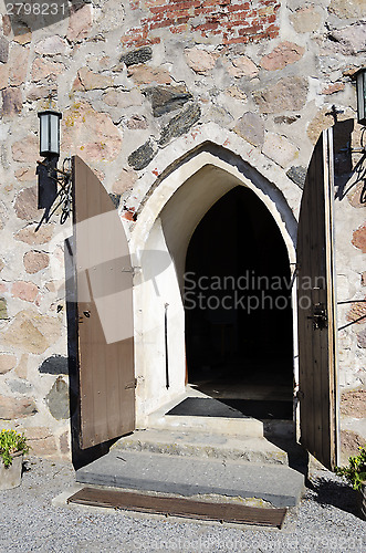 Image of open doors of medieval stone church