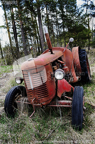 Image of old rusty tractor in the forest