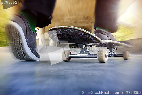 Image of Boy on a used skateboard