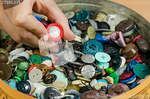 Image of Dish of colorful buttons and finger pick 