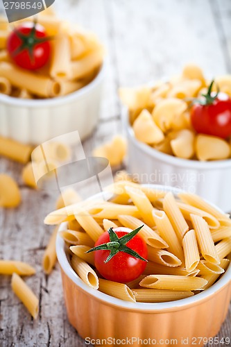 Image of uncooked pasta and cherry tomatoes