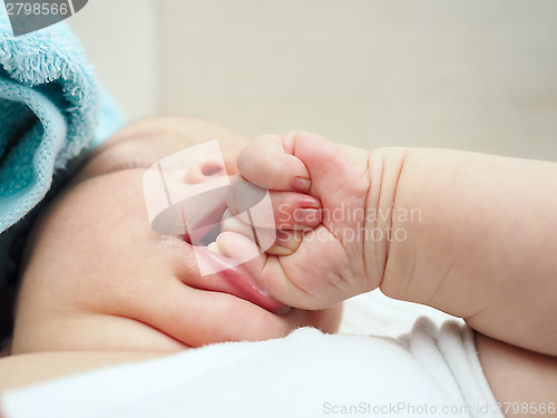 Image of Baby chewing on hand