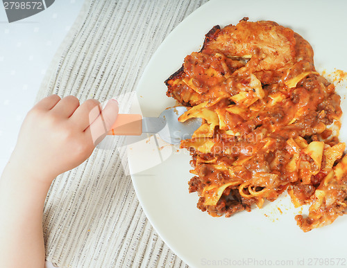 Image of Child and lasagna