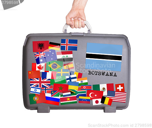 Image of Used plastic suitcase with stickers