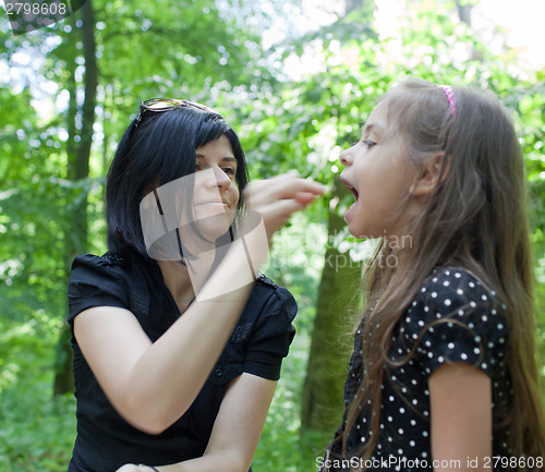 Image of Mother feeding daughter