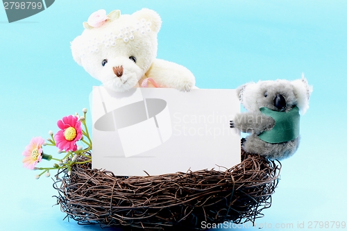 Image of Nest with a blank card and teddy bear and koala