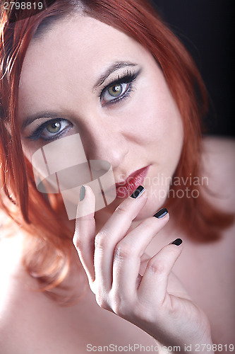 Image of Red head woman with black nails