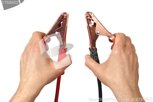 Image of Hands with jumper cables on white