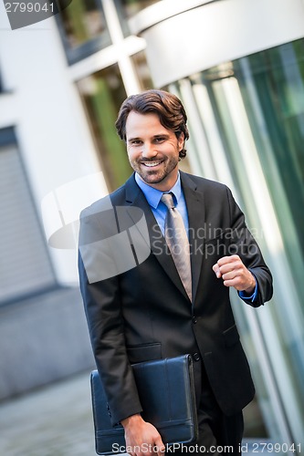 Image of Motivated businessman punching the air