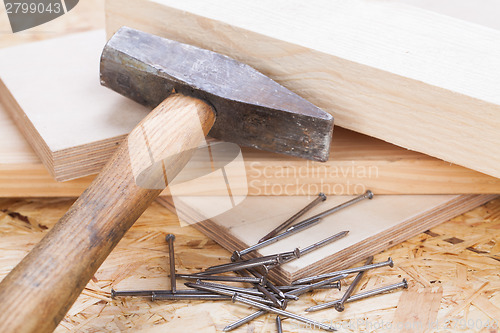 Image of Mallet with nails and planks of new wood